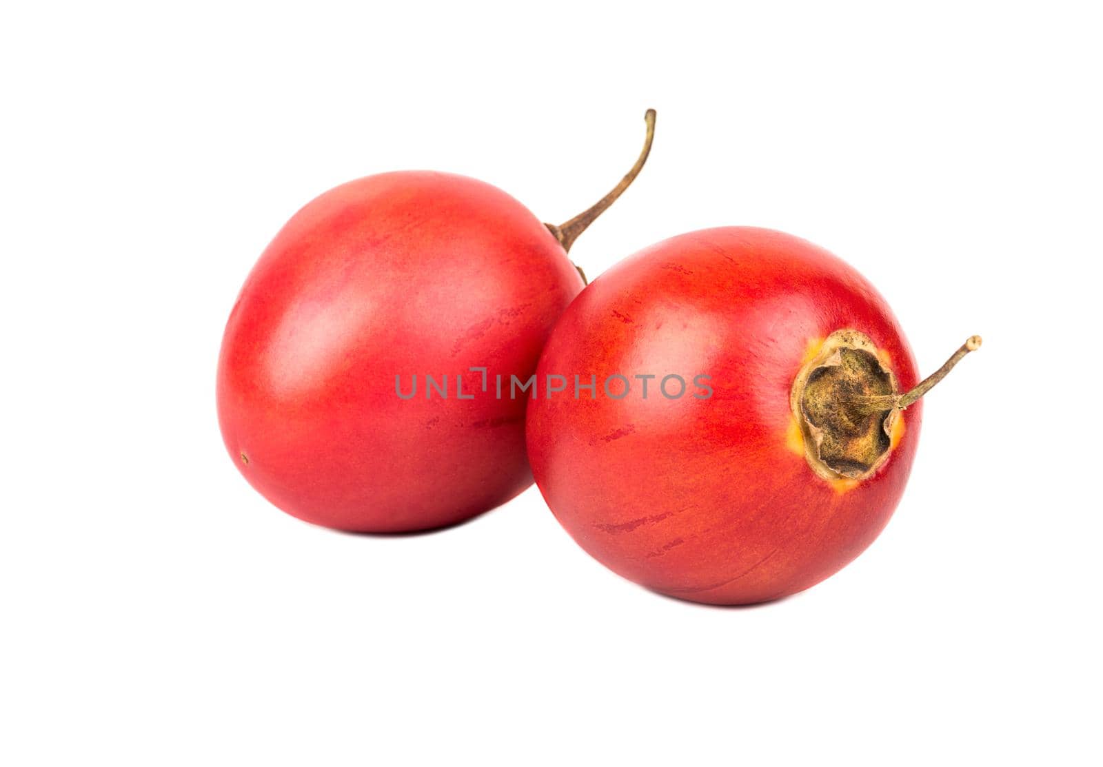 Two fresh exotic fruit tamarillo on white background