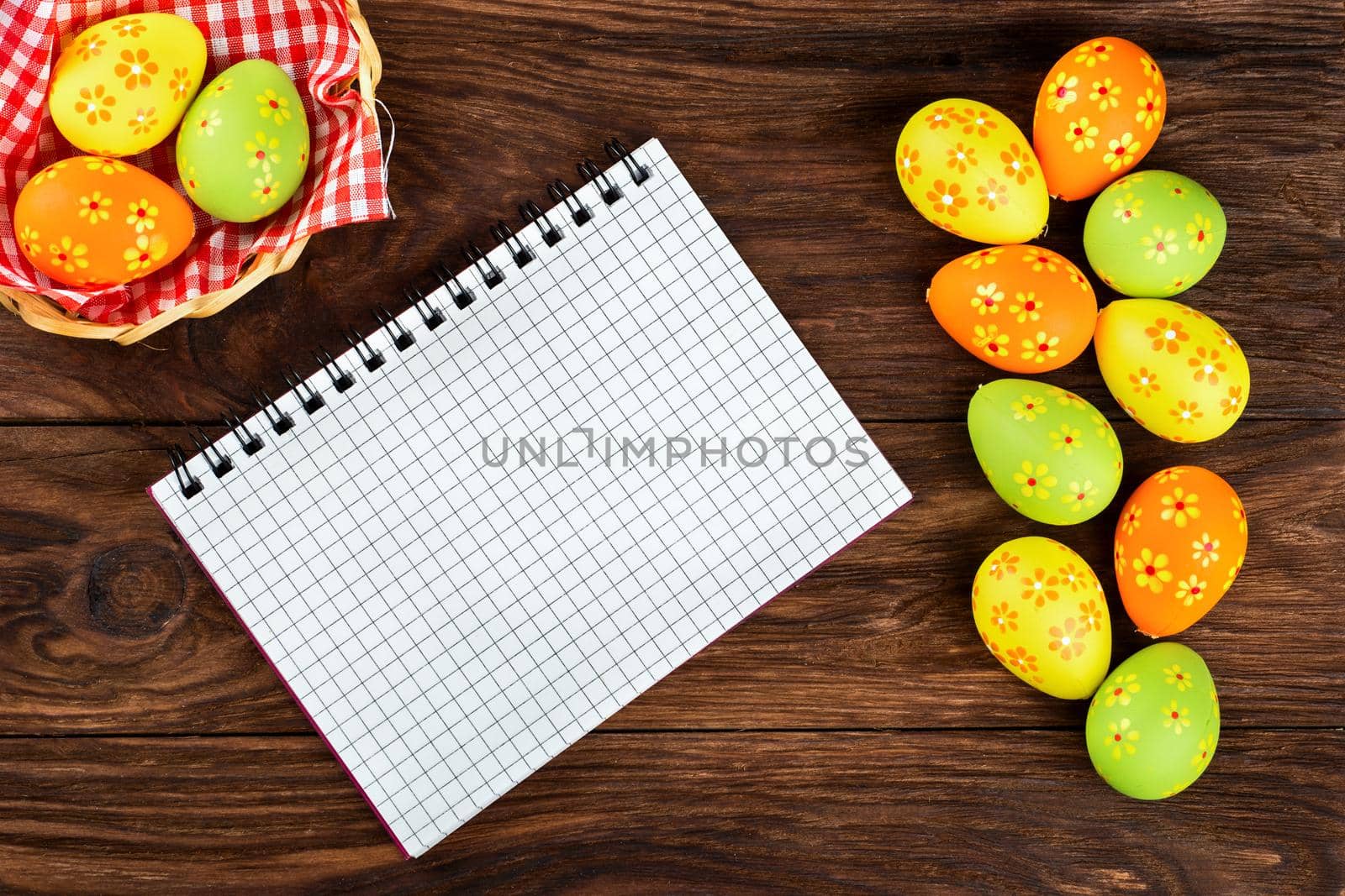 Blank notebook on a table with eggs for Easter greetings