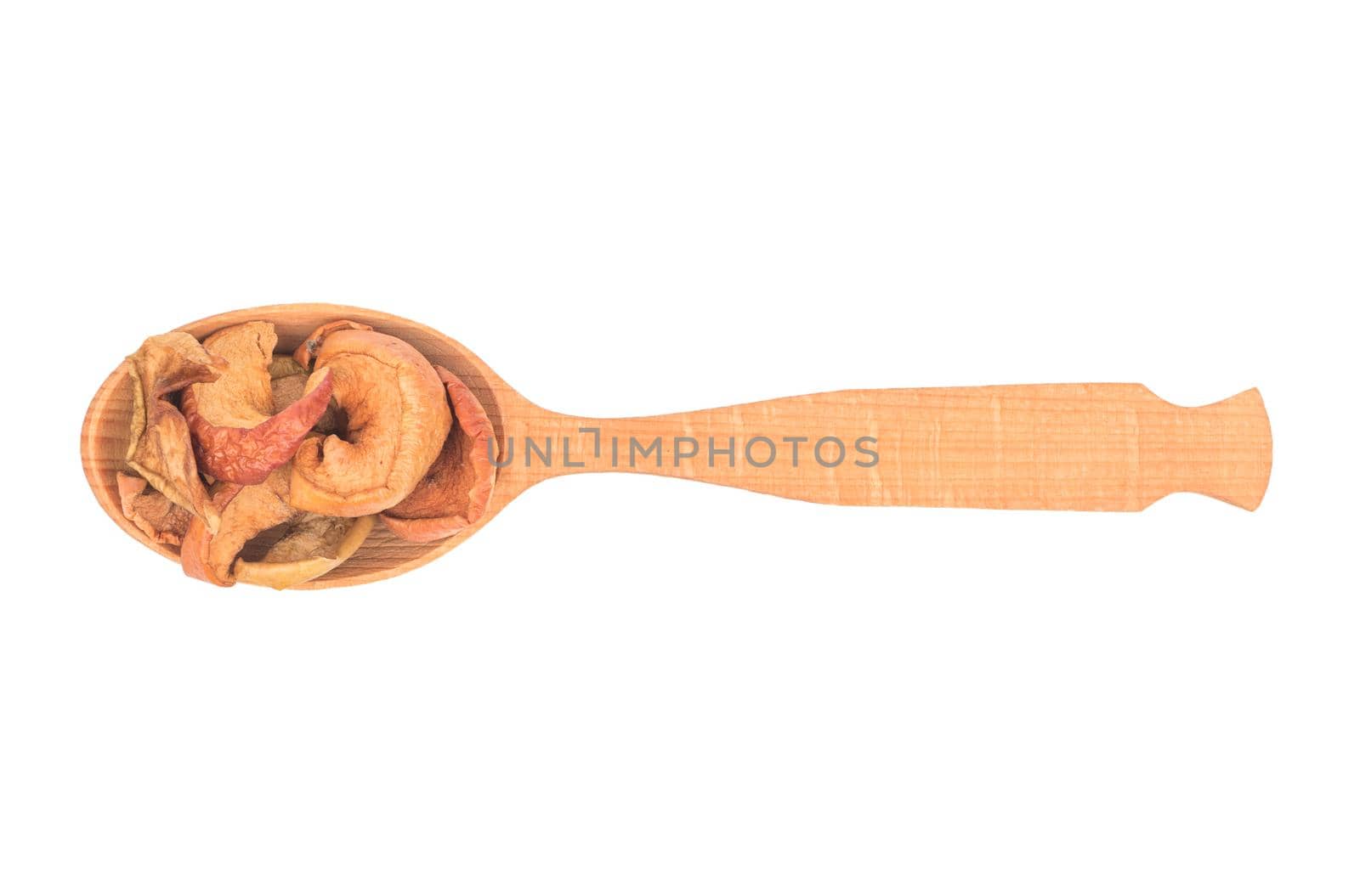 Wooden spoon with dry fruit slices of apple on white background, top view