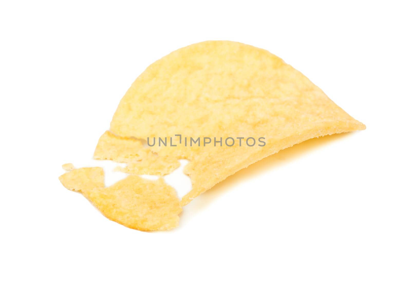 Potato chips broken into pieces on a white background