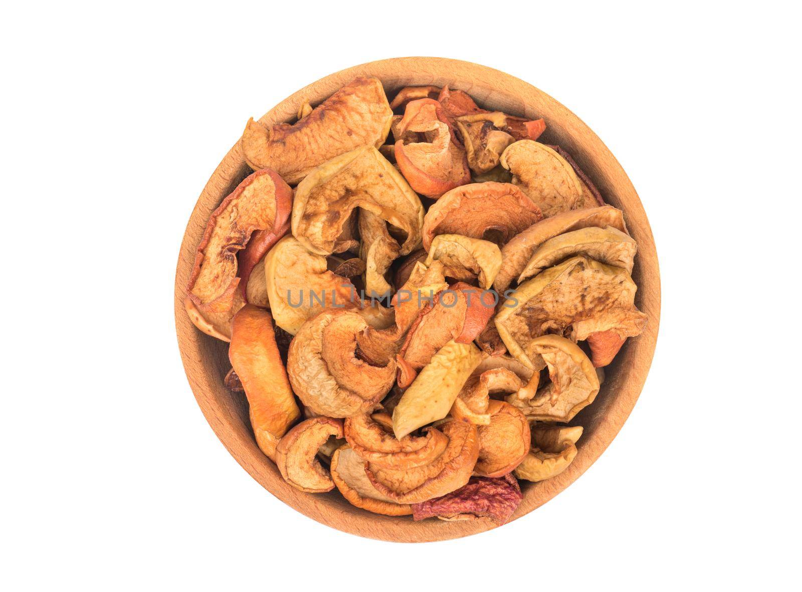 Slices of dry fruit apples in a bowl isolated on white background, top view