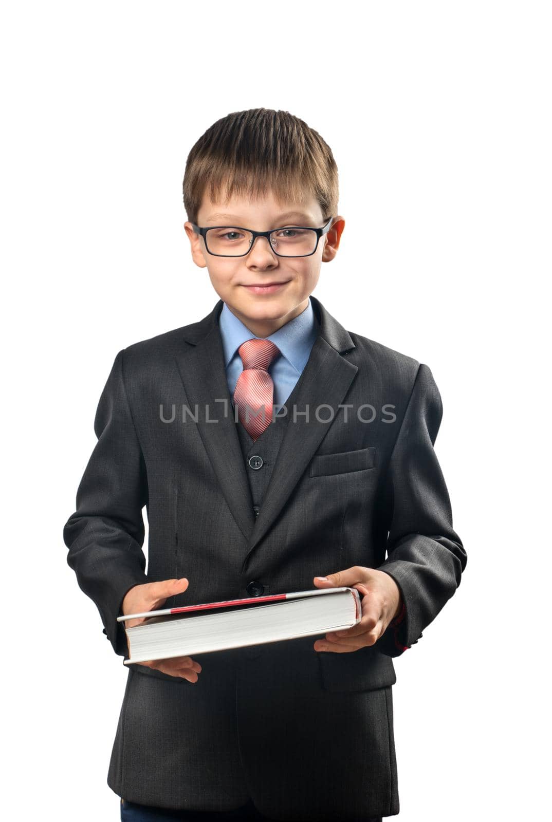 Cute schoolboy with glasses is holding a book