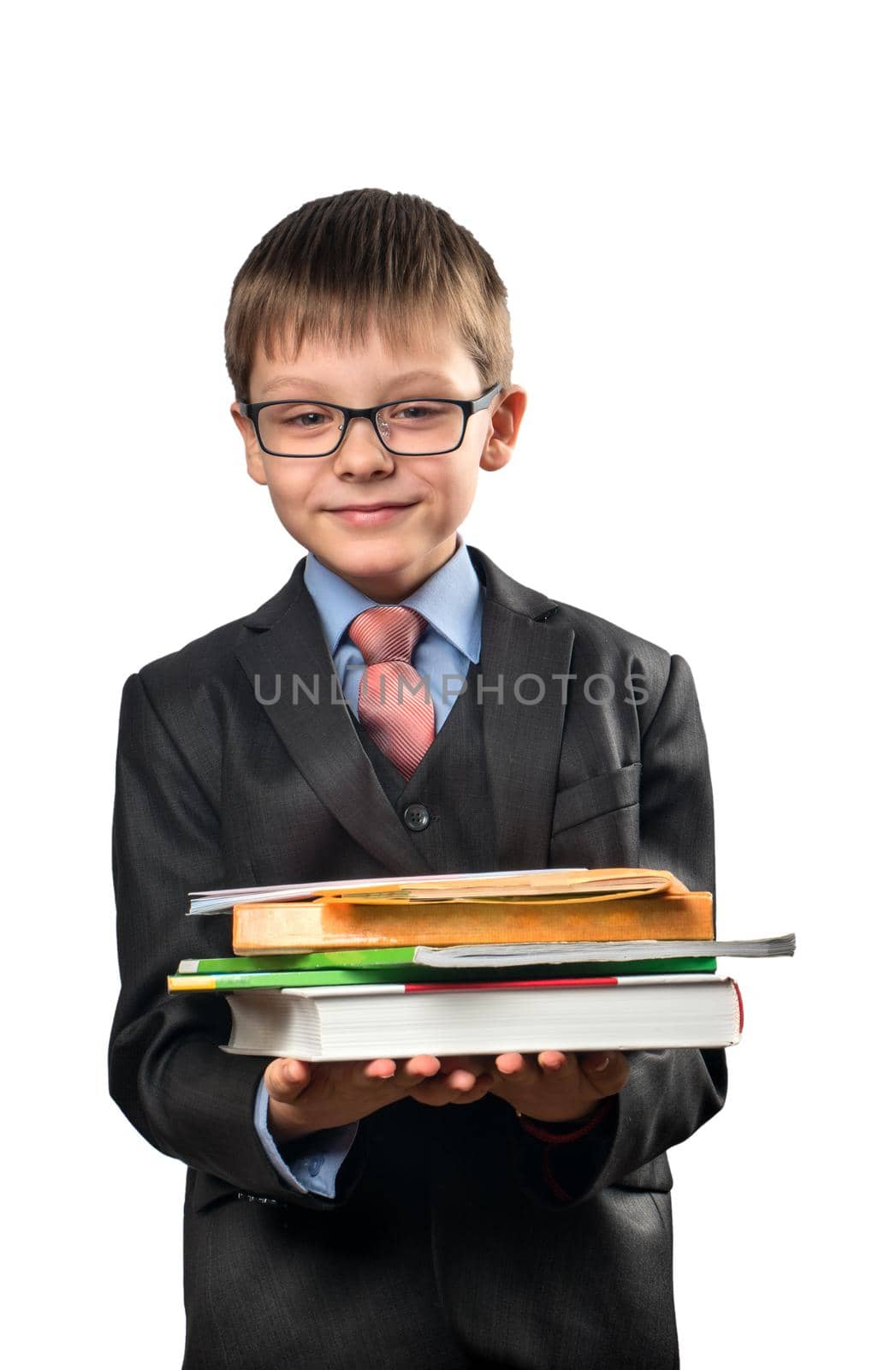 Schoolboy holding a stack of books in the hands on a white background