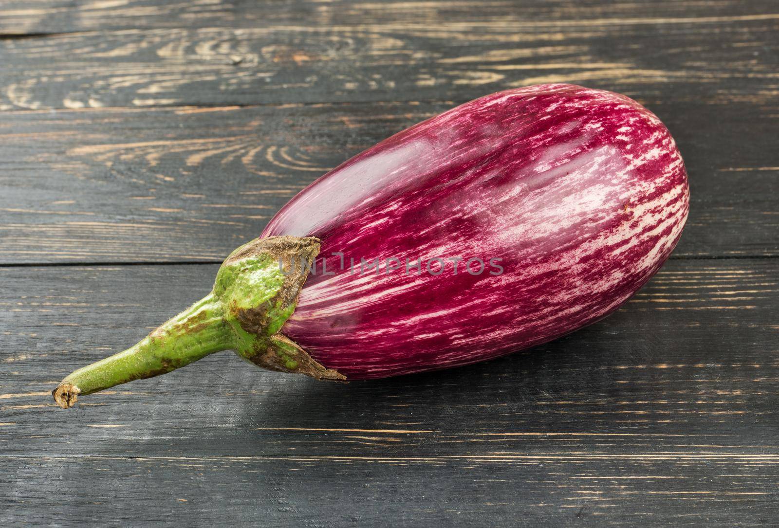 Fresh purple eggplant graffiti on the table