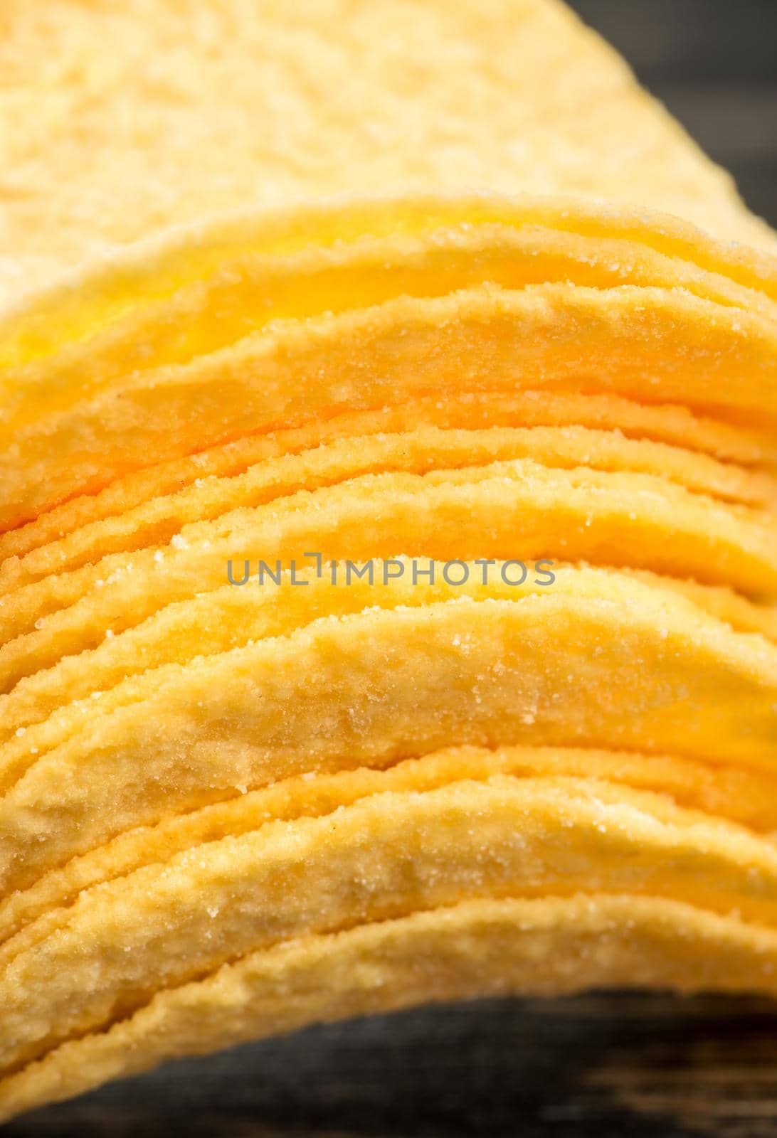 Stack of potato chips with cheese flavor close-up