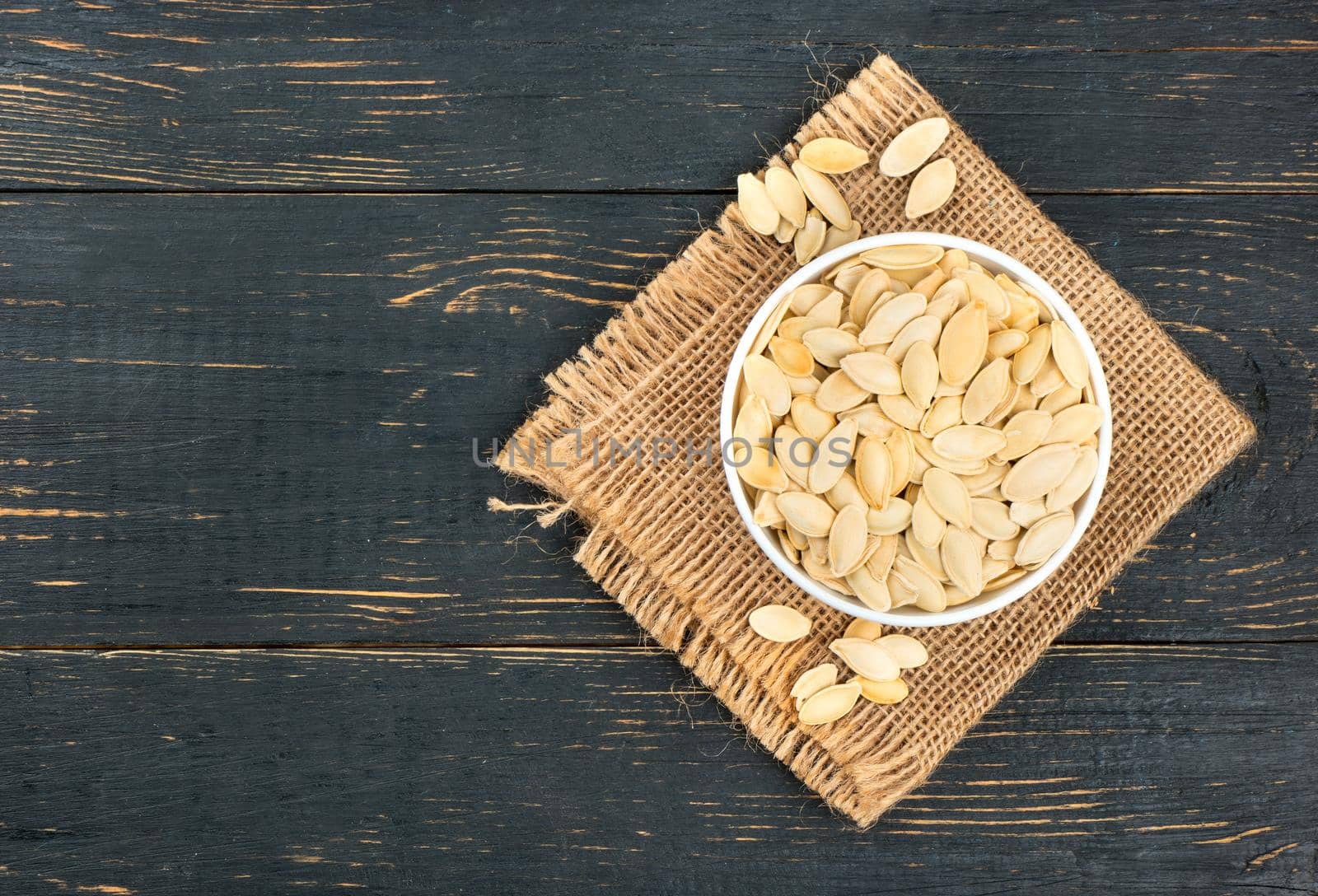 Pumpkin seeds in bowl by andregric