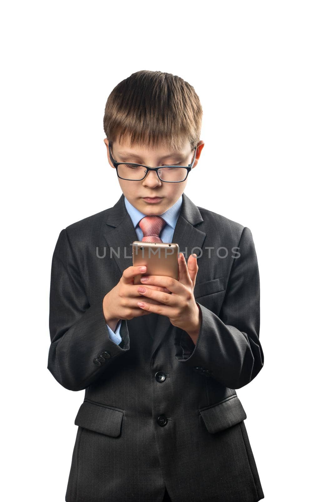 Schoolboy wearing glasses playing on phone on white background