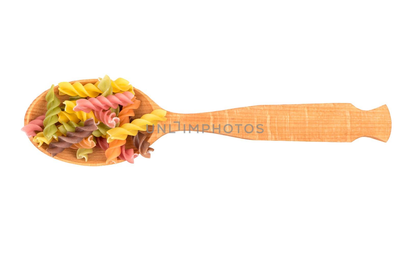 Wooden spoon with colored pasta fusilli on white background, top view