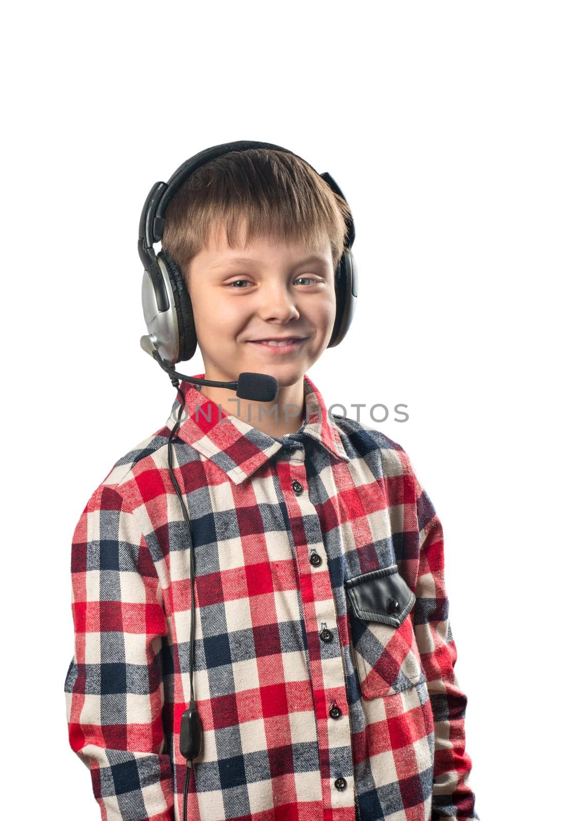 Little boy in headphones with microphone on white background