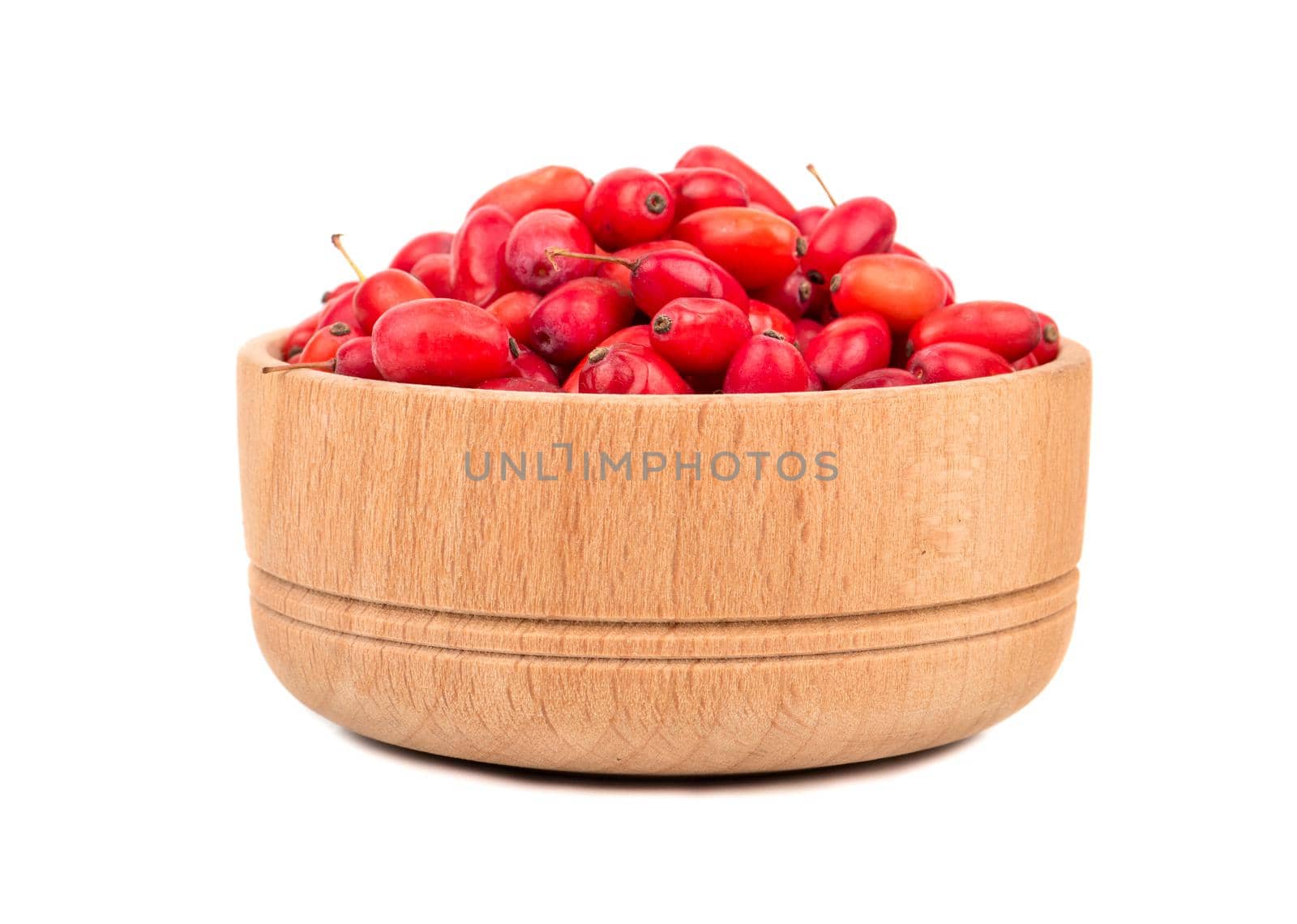 Fresh barberries in a small wooden bowl on white background