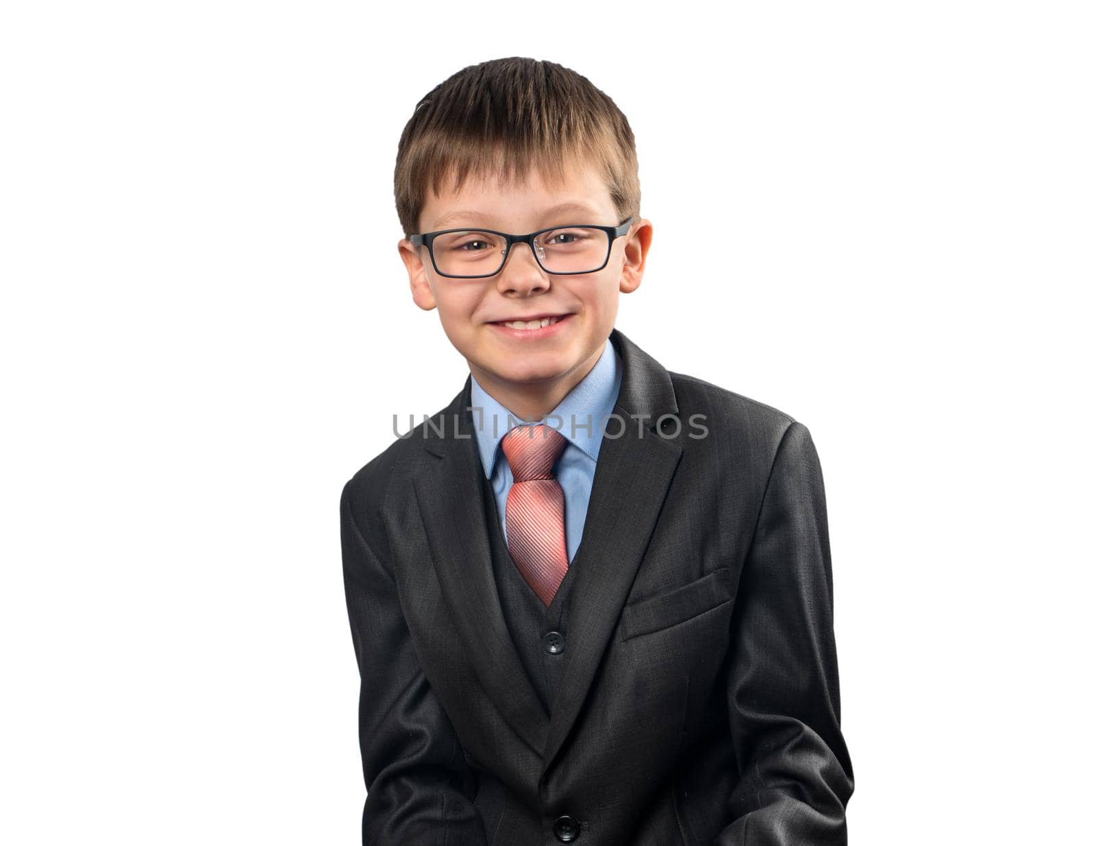 Portrait of smiling schoolboy in a suit on white background