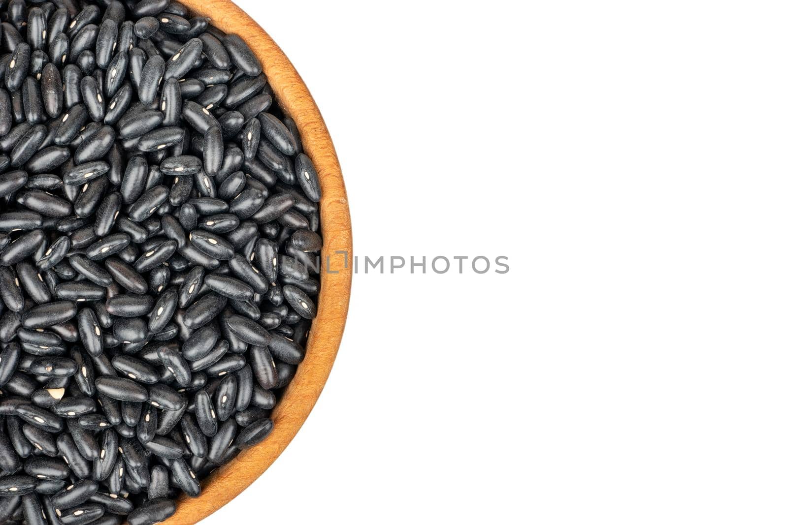 Part of a bowl of black beans on a white background close-up