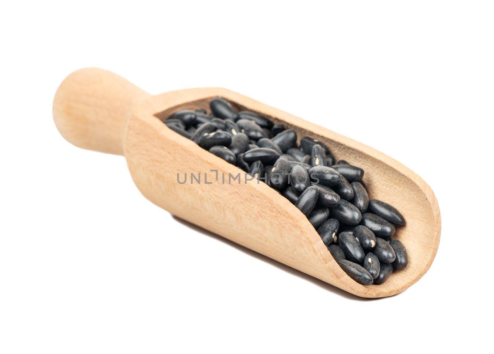 Wooden scoop with black beans isolated on white background