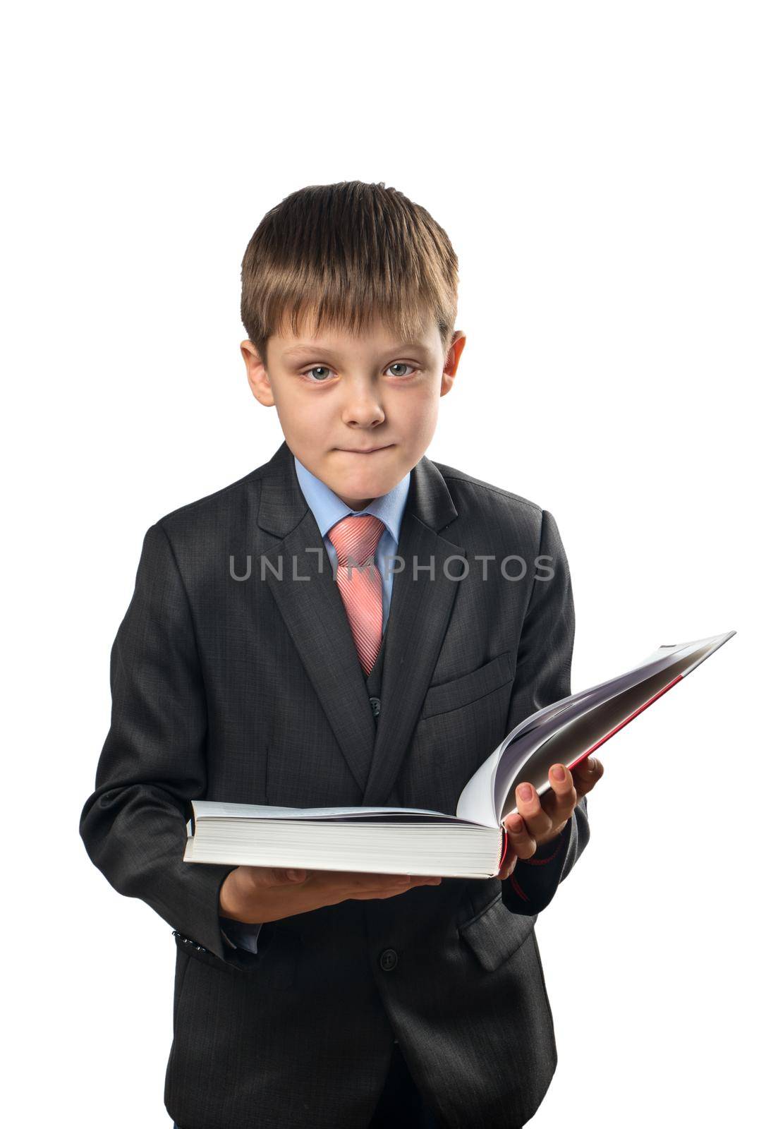 Cheerful schoolboy holding an open book in his hands on a white background