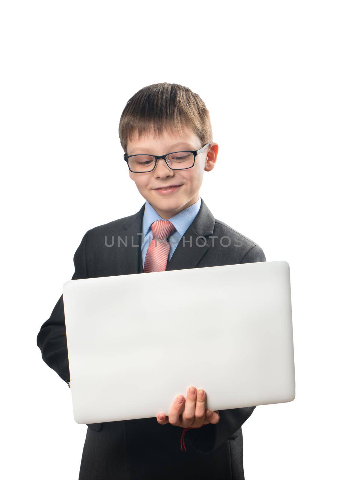 Schoolboy holding a laptop and communicating on the Internet on a white background