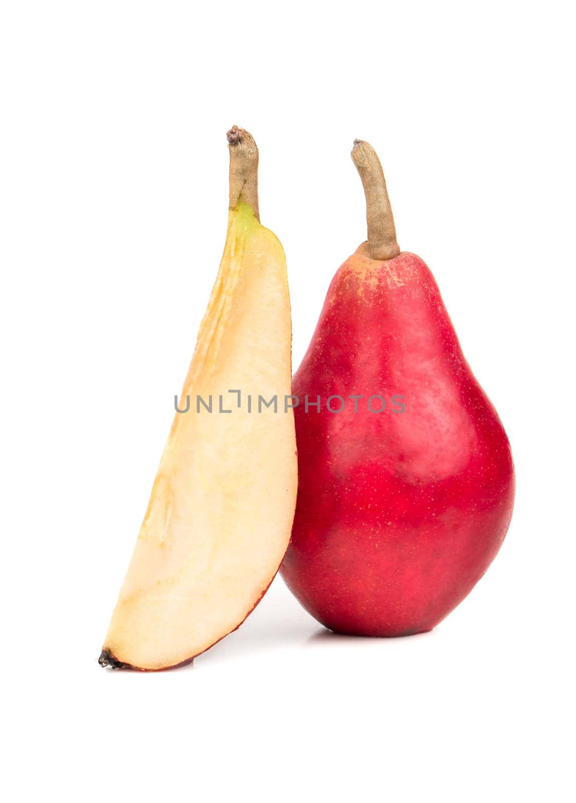Ripe red pear with a slice isolated on white background