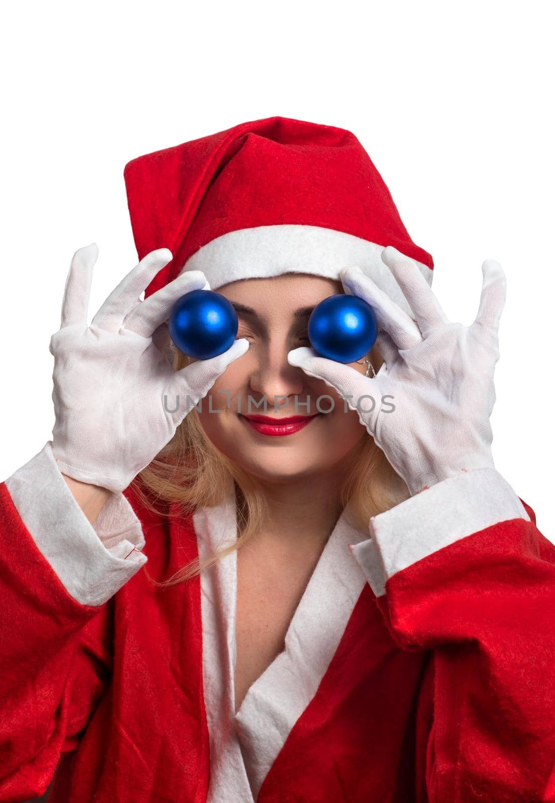 Girl in Santa suit holding in his hands balls near the eyes, on a white background