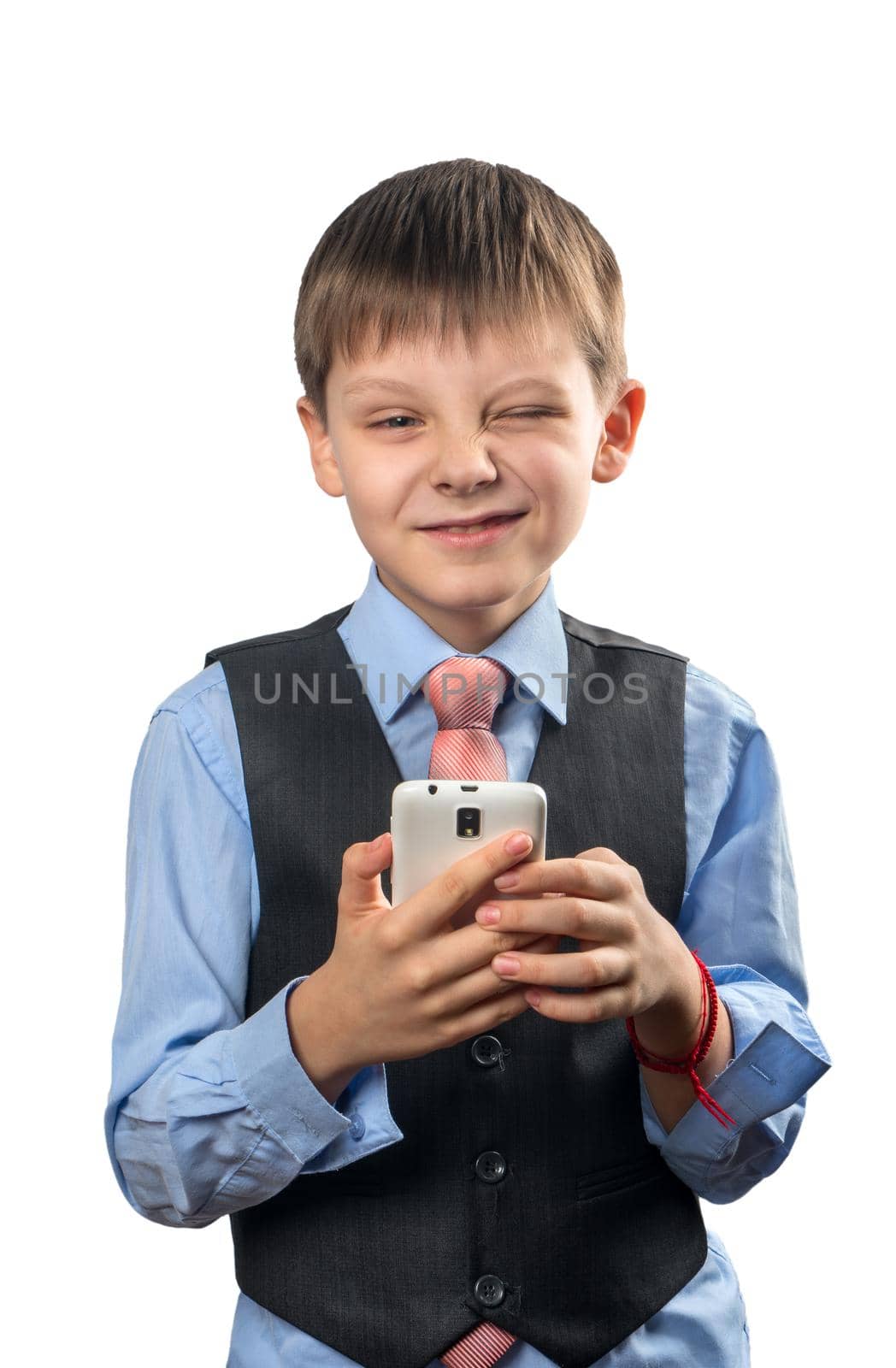 Schoolboy holding a smartphone and winking on a white background