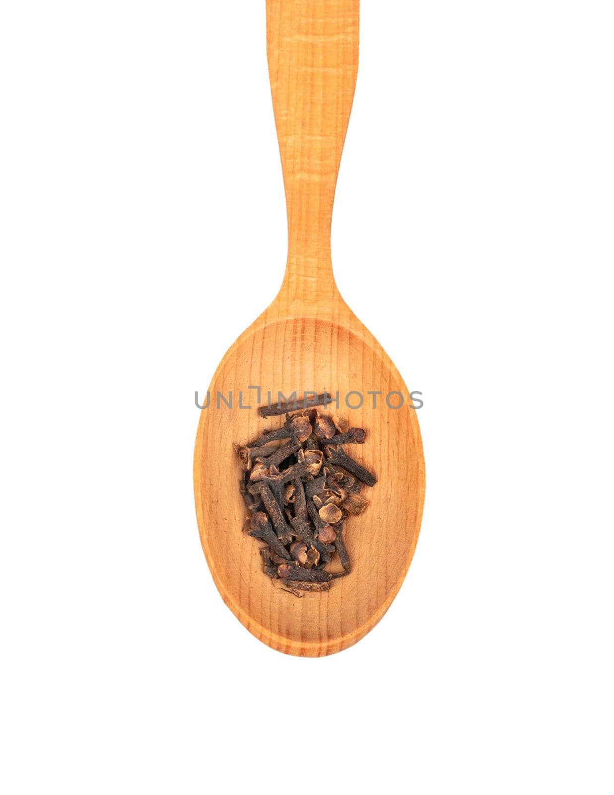 Big spoon with the dry spice cloves isolated on white background closeup, top view