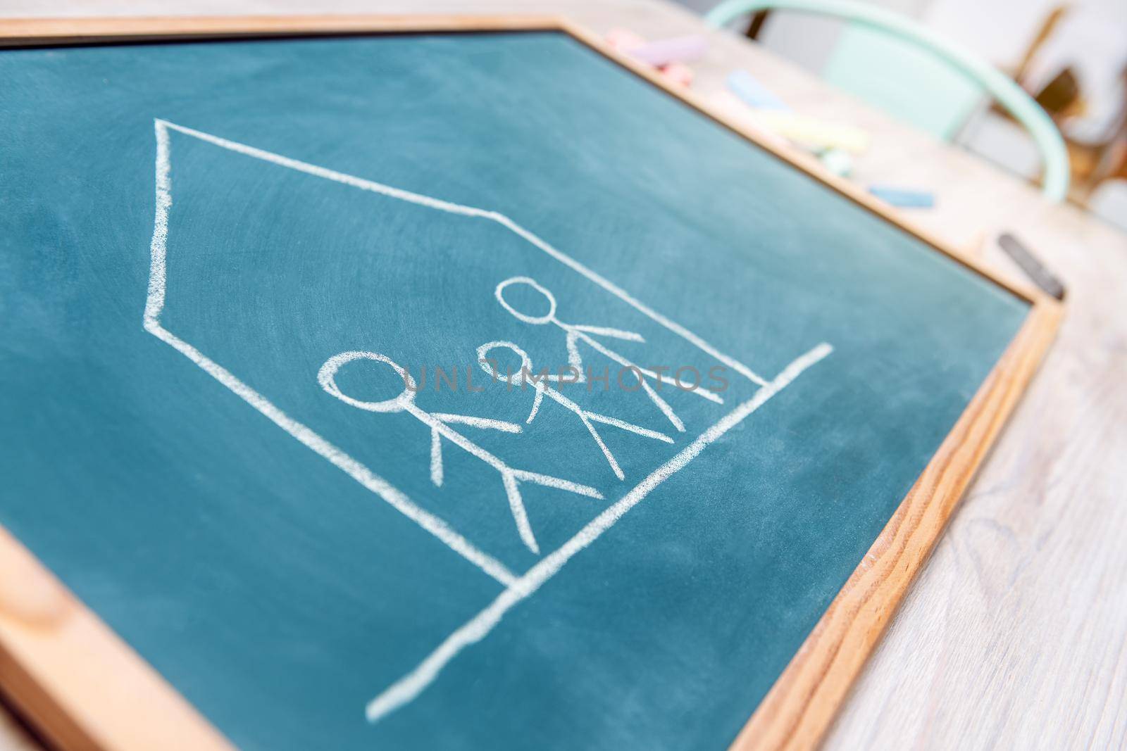confined family drawn on a blackboard, concept of quarantine with children