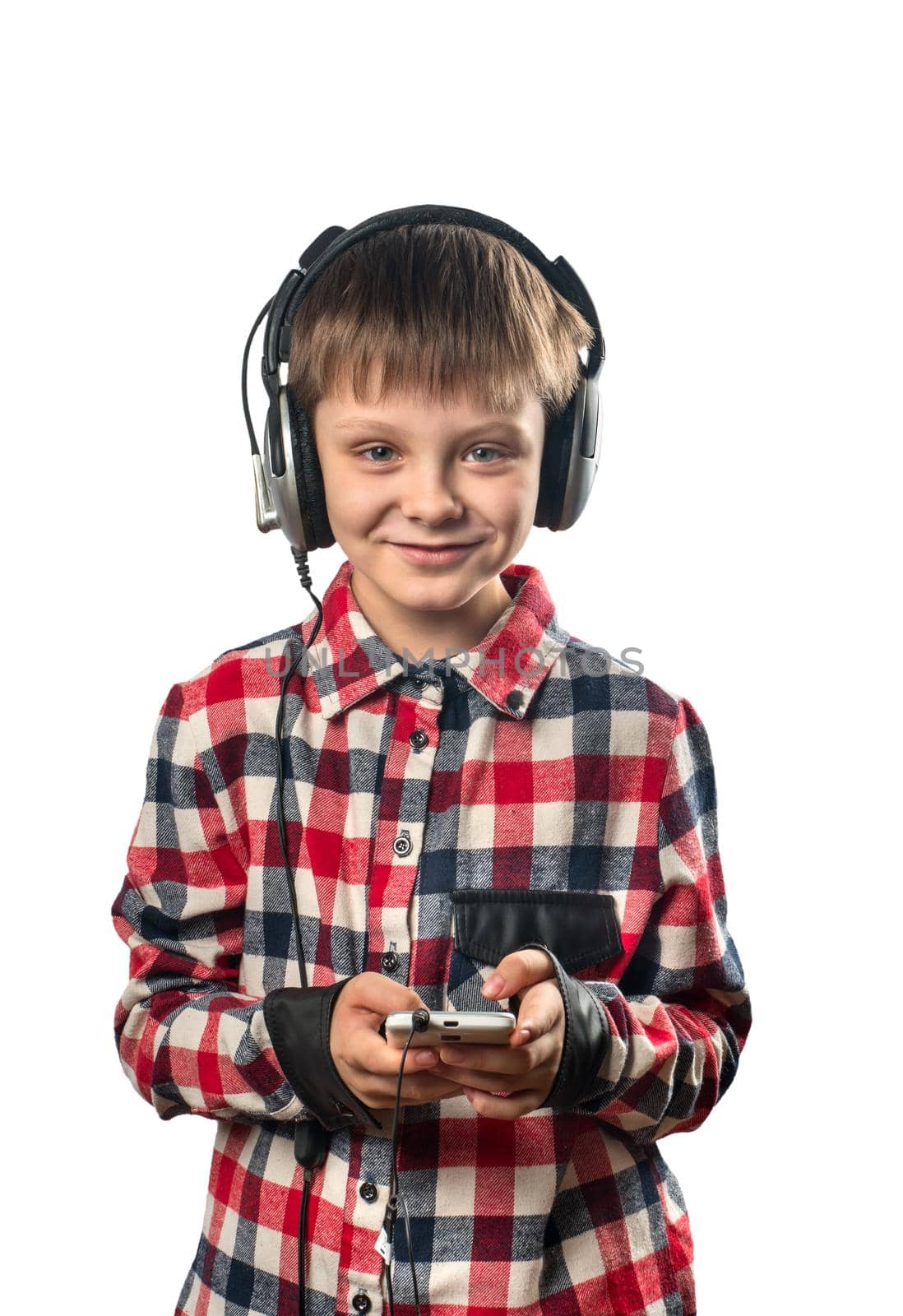 Boy listening to music on headphones with a smartphone on a white background