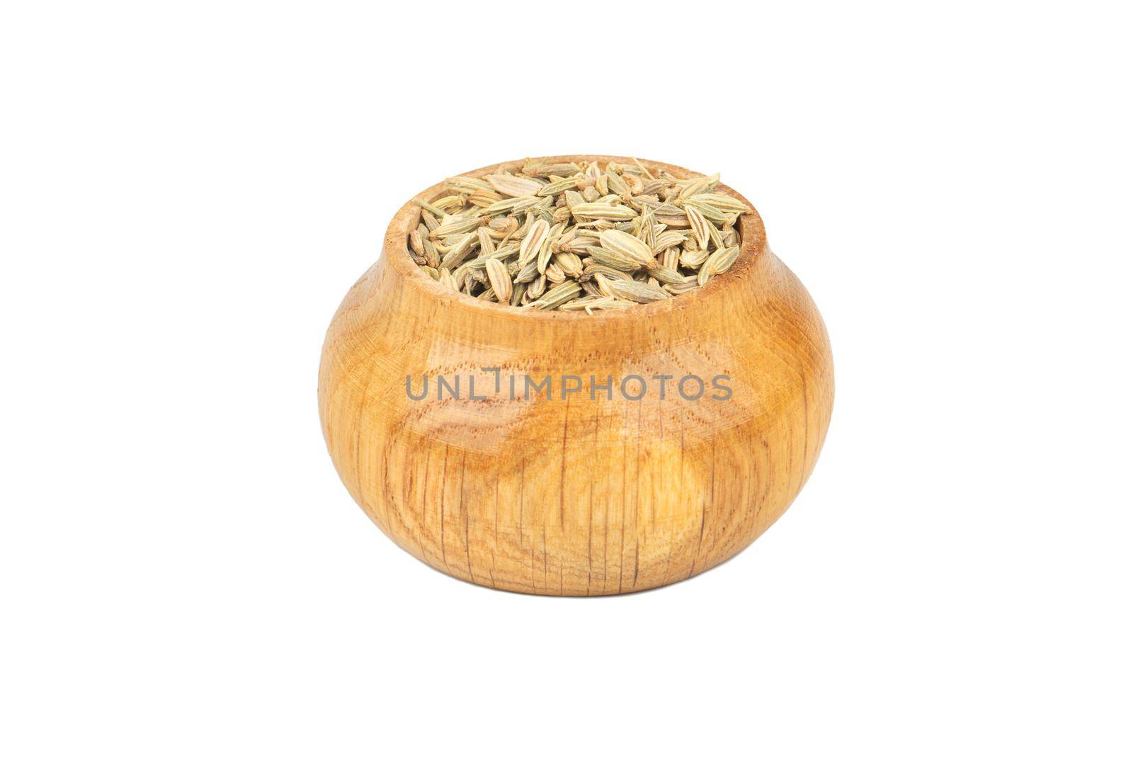 Spice dry fennel in wooden container isolated on white background