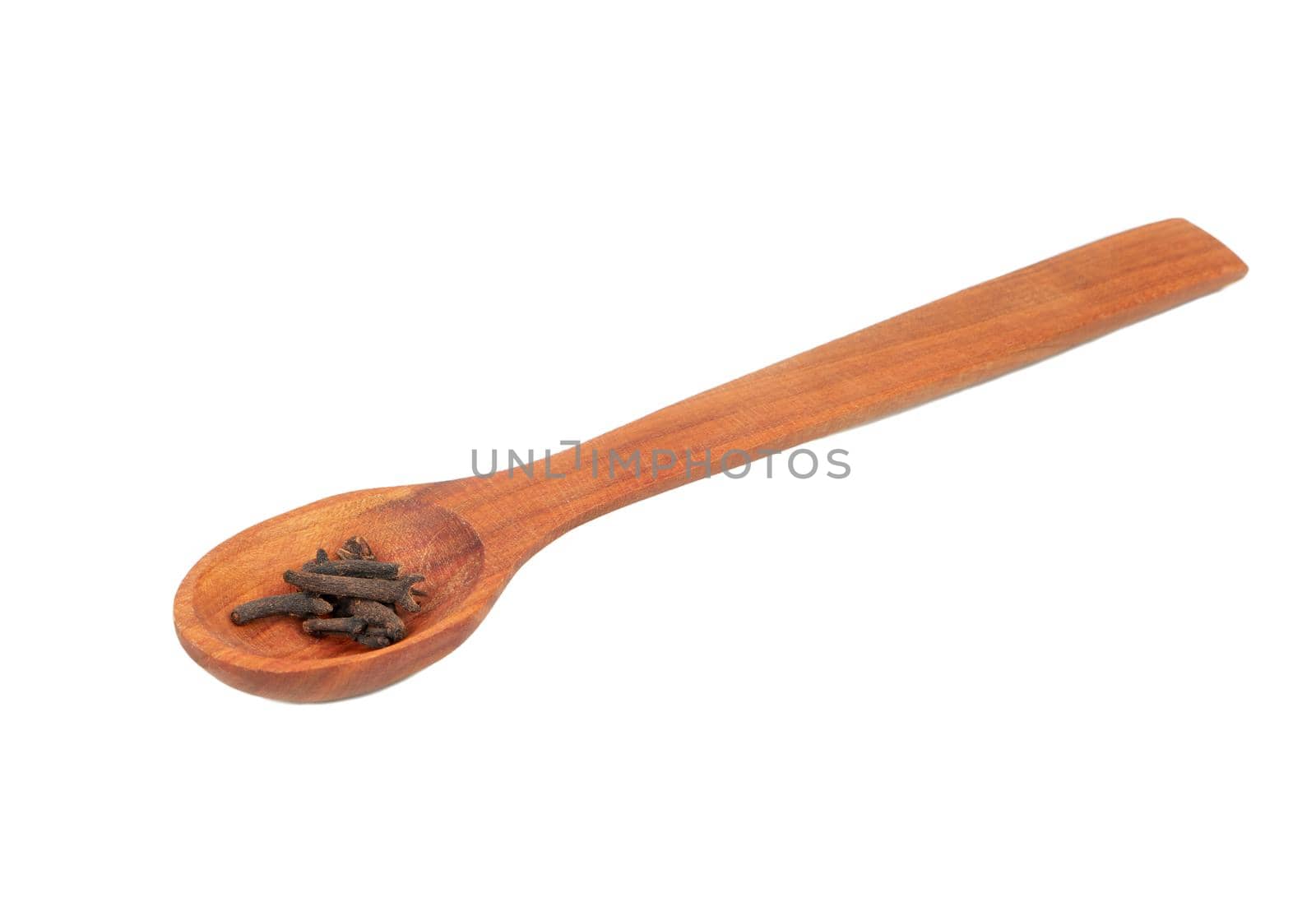 Dry cloves in wooden spoon isolated on white background