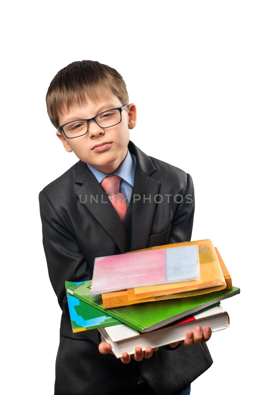 Schoolboy hard to hold in his hands a lot of books on a white background