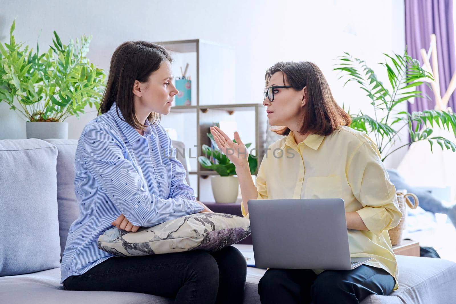 Young woman patient on individual therapy in psychologists office. Mature female counselor listening taking notes talking. Psychology, psychiatry, treatment, mental health concept