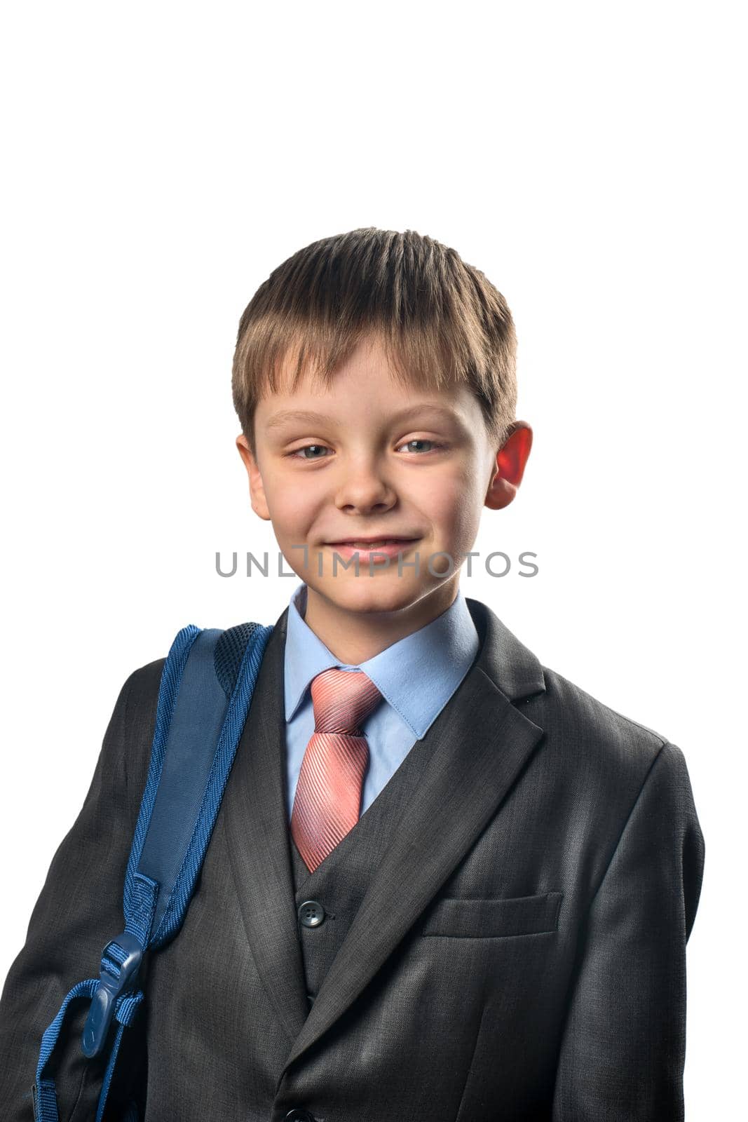 Portrait of a cheerful schoolboy in blazer on white background