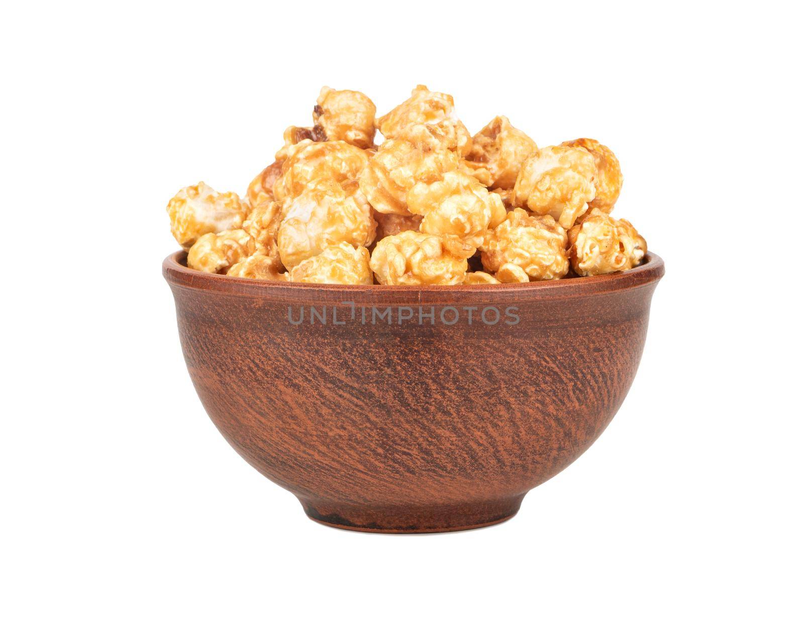 Ceramic bowl with caramel popcorn isolated on white background