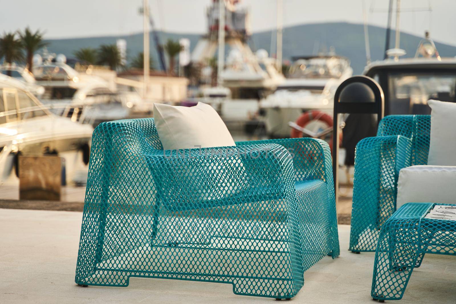 Wicker blue chairs and a table. Summer outdoor furniture on the seashore by driver-s