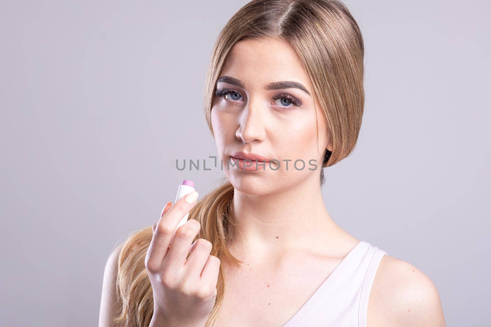 Beautiful Woman With Beauty Face Applying Lip Balsam, Lips Skin Care. Lipbalm On Sexy Lips. Portrait Of Female Model With Soft Skin And Natural Nude Makeup. High Resolution Stock Photo