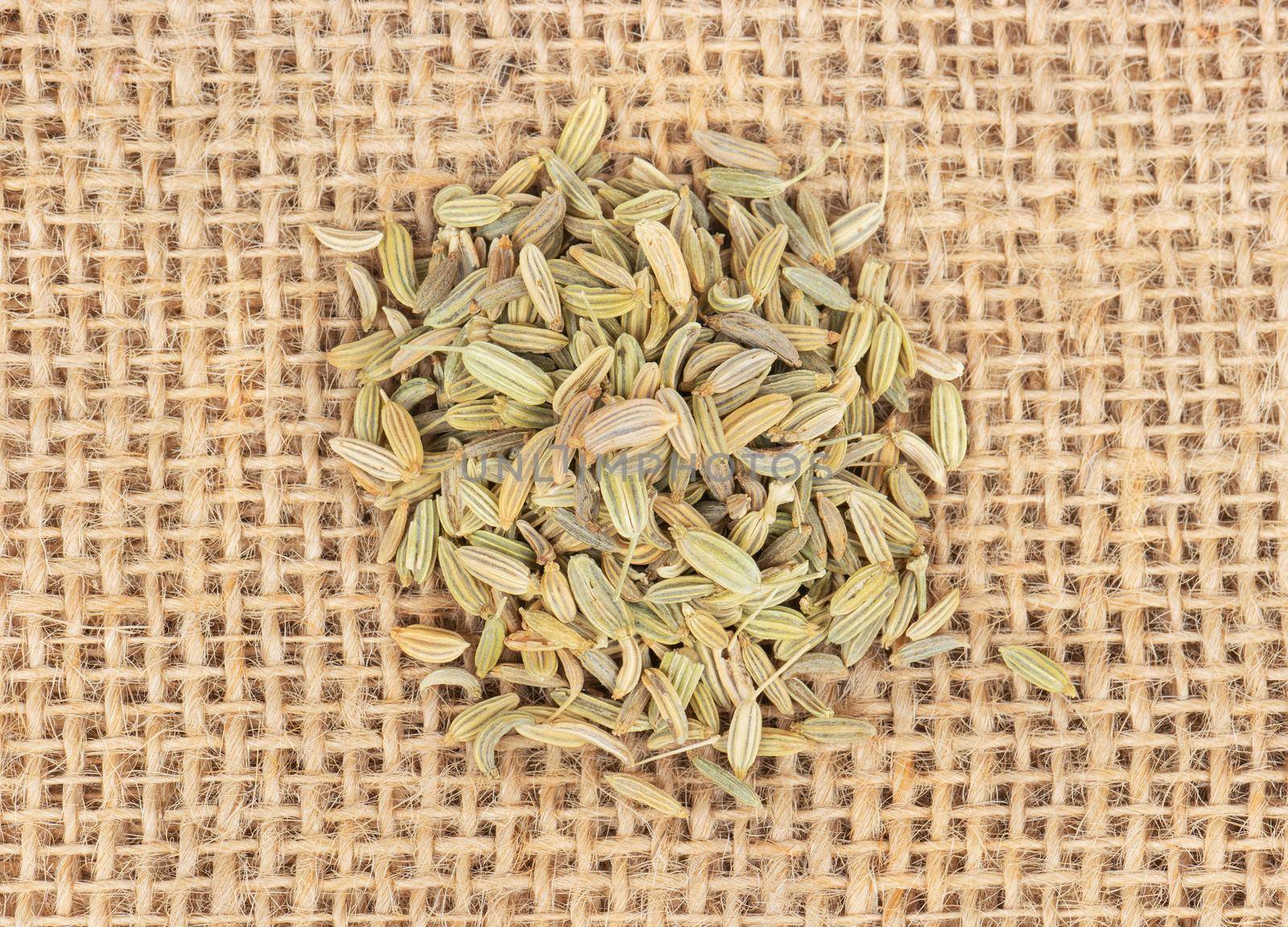Bunch of dry spices of fennel close up on sackcloth, top view