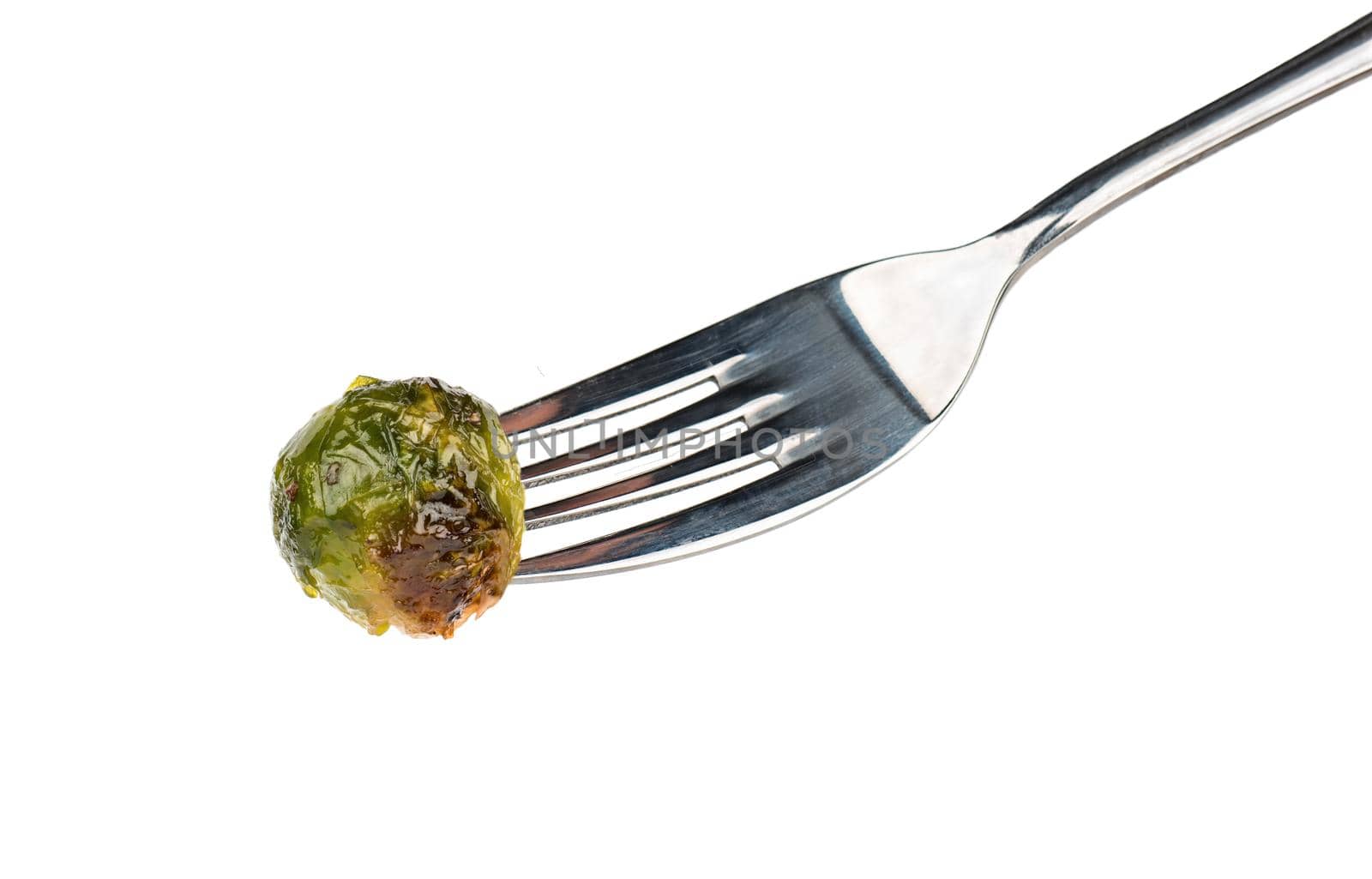 Fried brussels sprouts on fork isolated on a white background