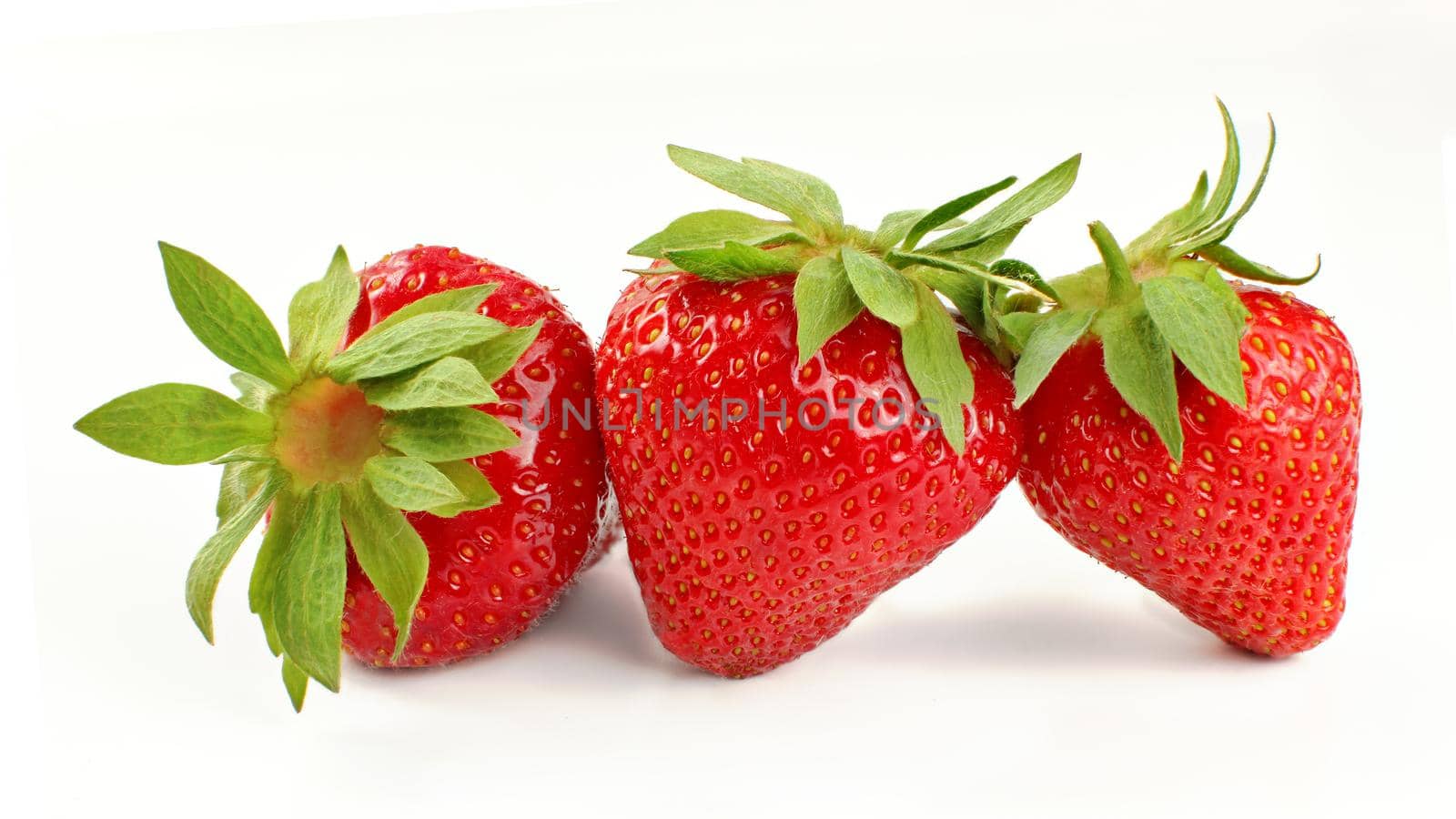 Three ripe strawberries isolated on white background.