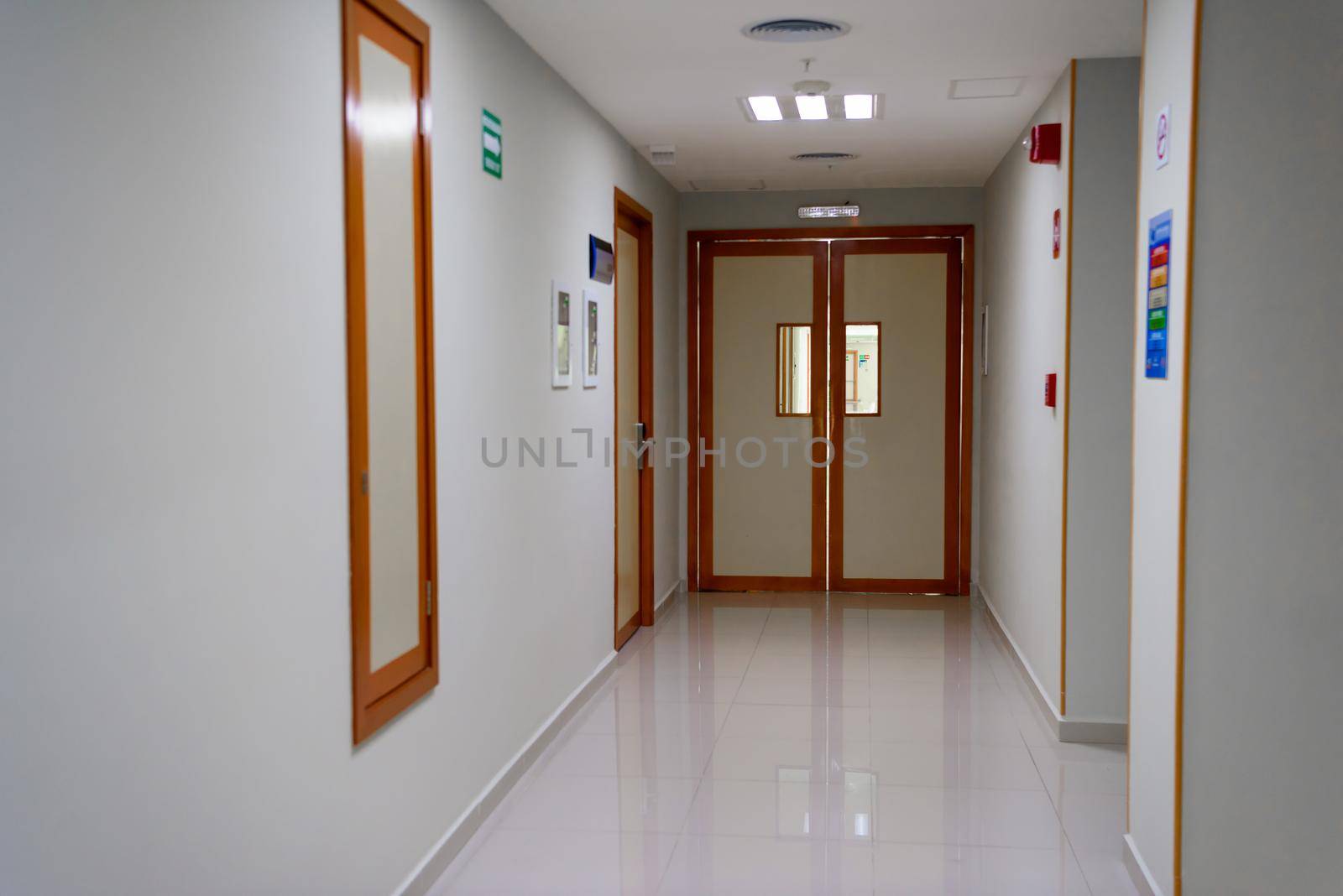 The door to the hospital in a white hallway.