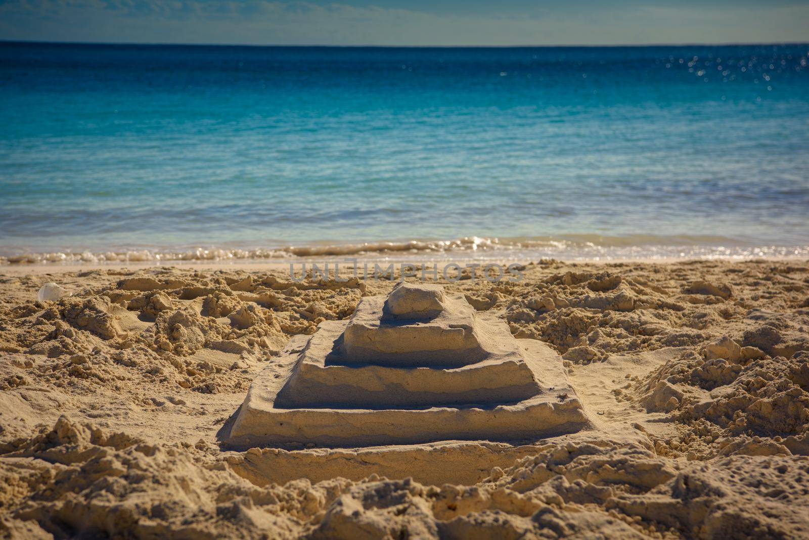 Pyramid of sand on the shores of the sea.