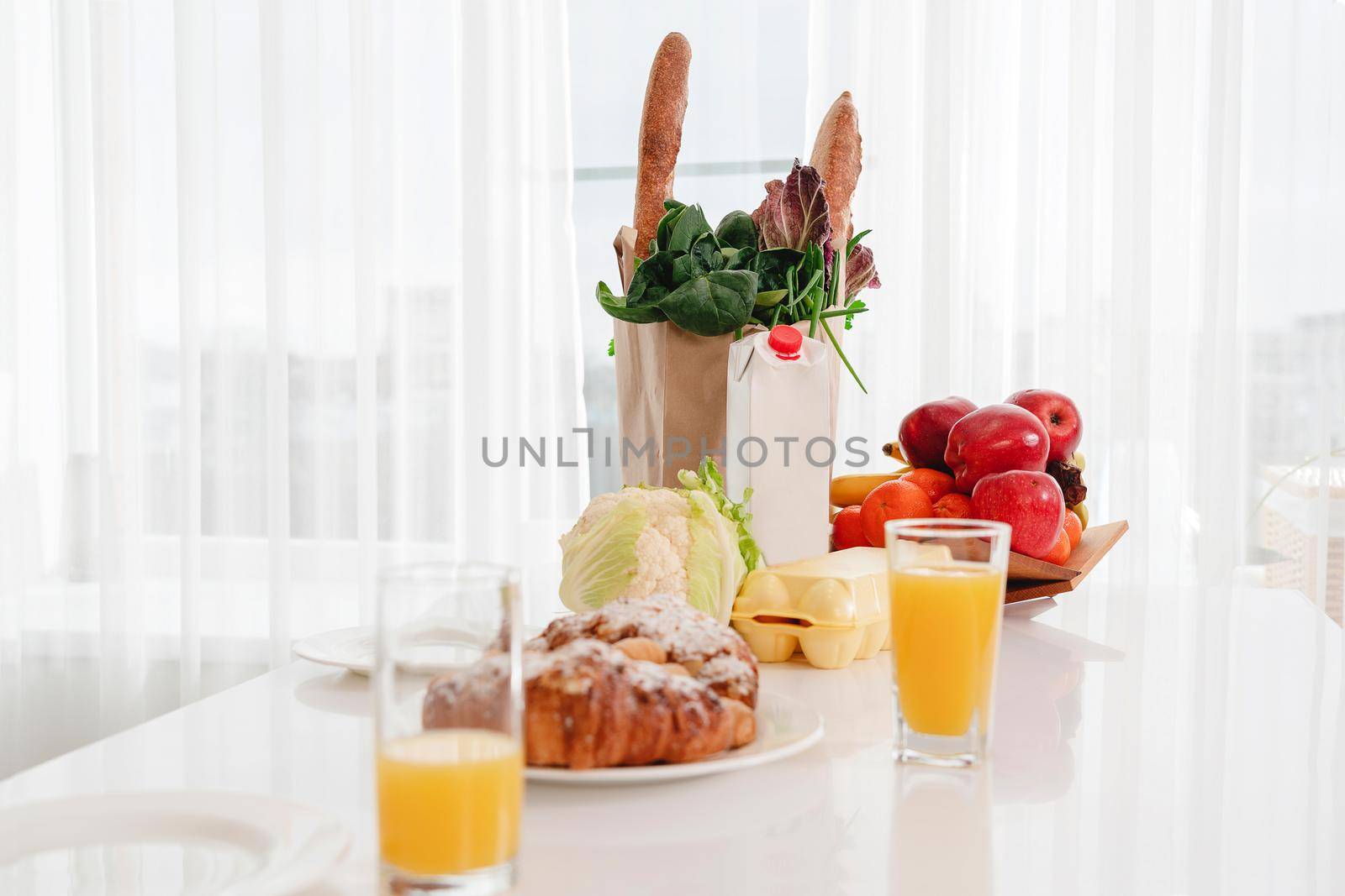 A plate of food on a table next to a window. High quality photo