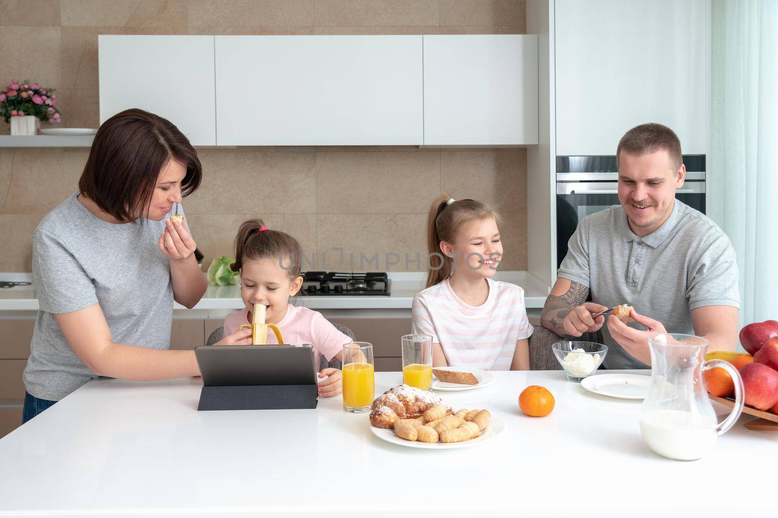 Smiling Family Dining Together at kitchen table