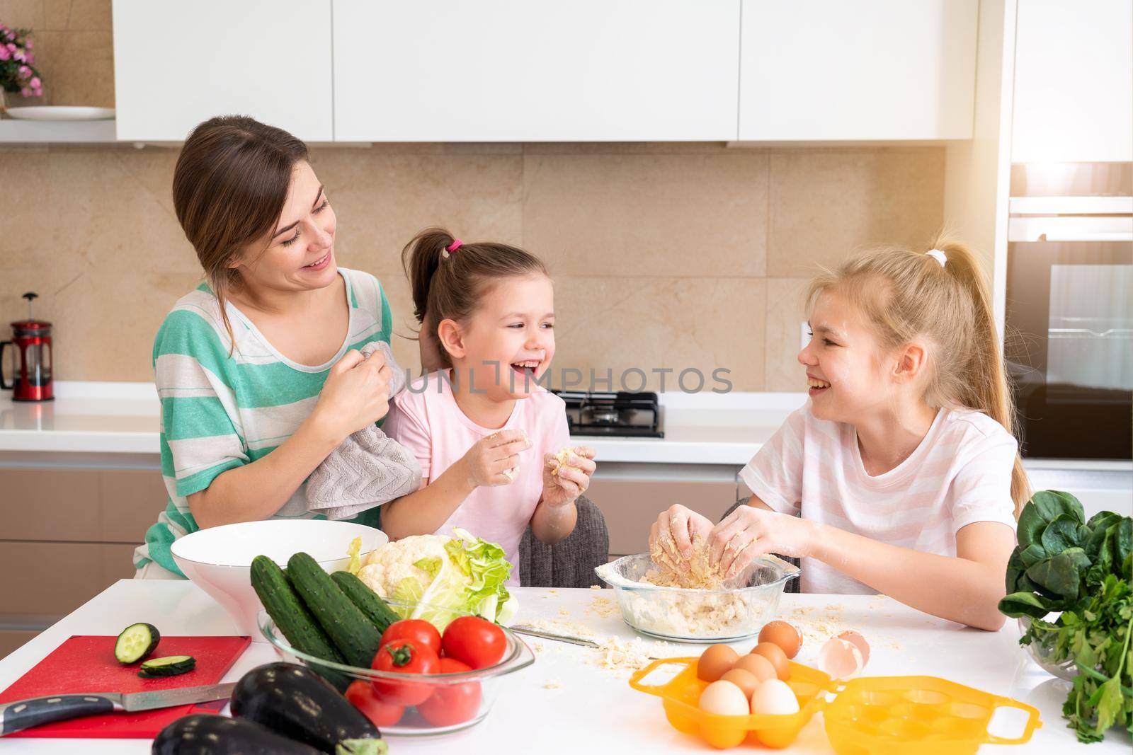 happy family funny kids are preparing the dough, bake cookies in the kitchen