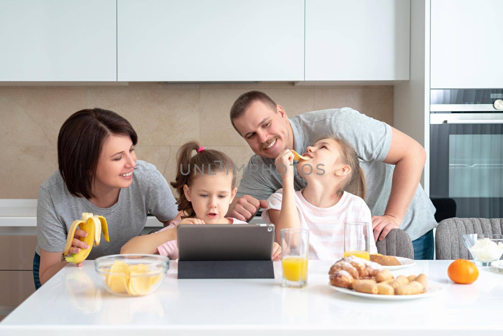 Smiling Family Dining Together at kitchen table