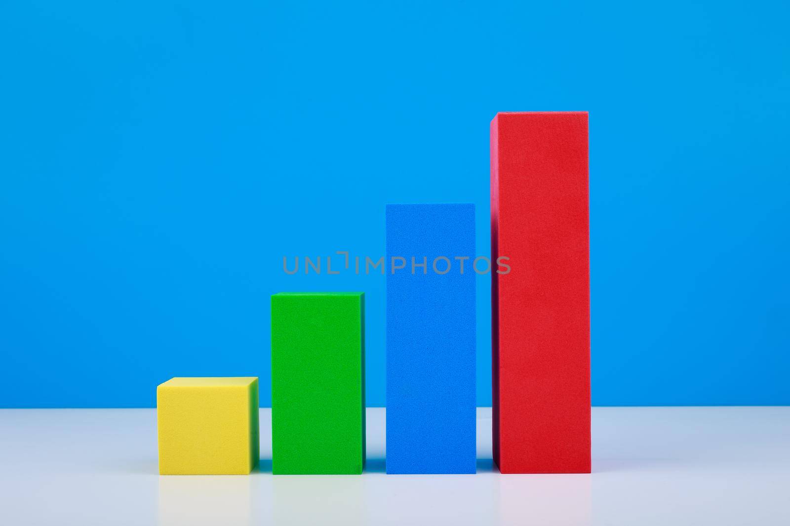 Business concept. Multicolored graph diagram with rise dynamic against blue background. Chart for marketing, annual or corporate report, sales or growth evaluation or analytic or profit growing