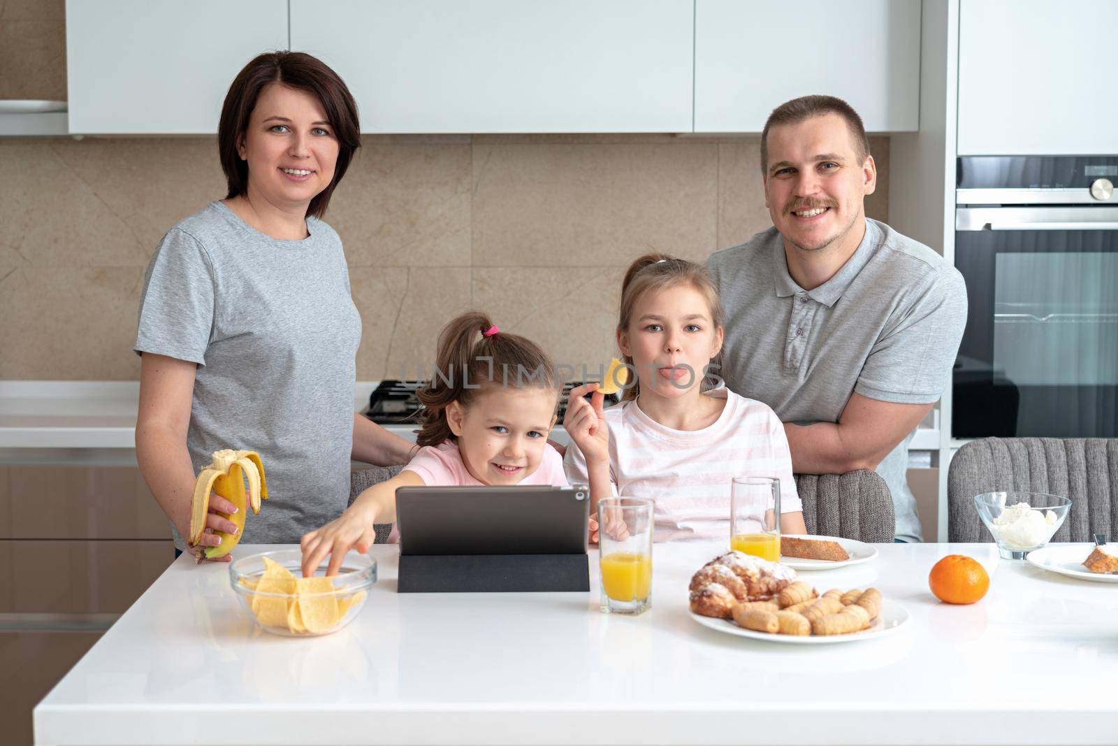 Smiling Family Dining Together at kitchen table