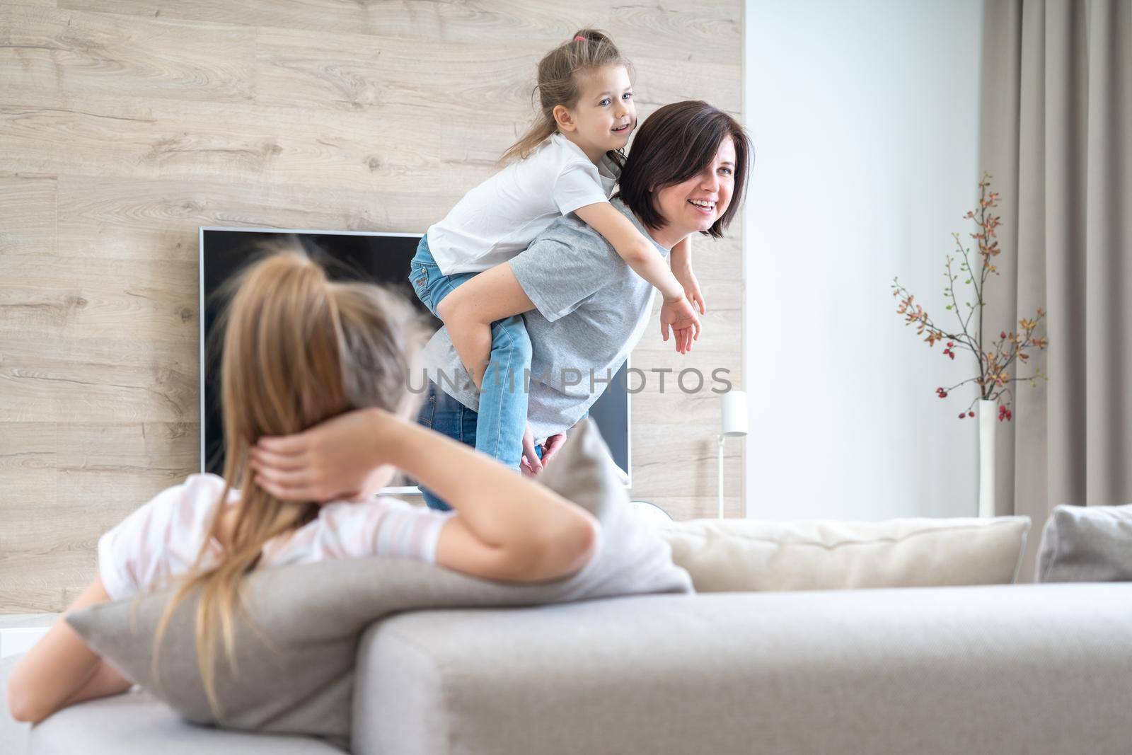 A little girl sitting on a couch. High quality photo