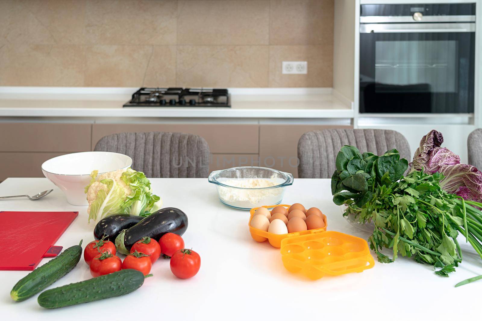 egg box and fresh vegetables on kitchen table