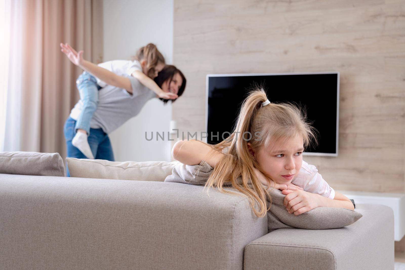 A little girl sitting on a couch. High quality photo
