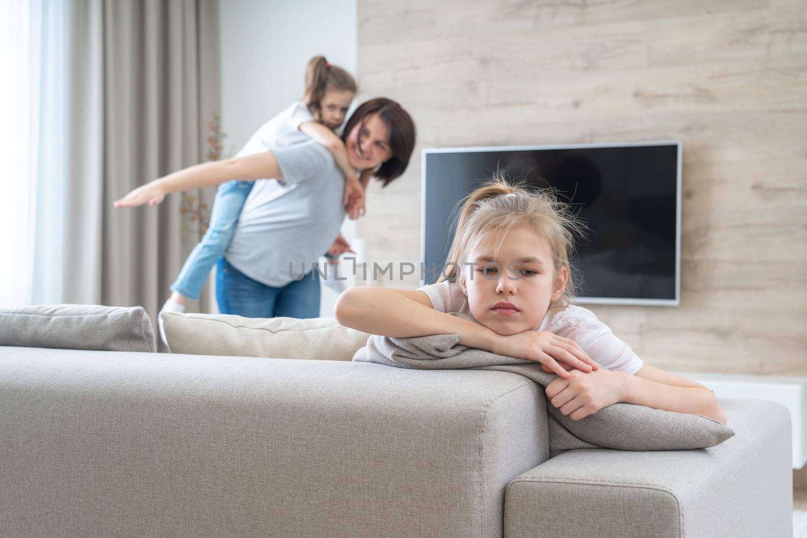 A little girl sitting on a couch. High quality photo