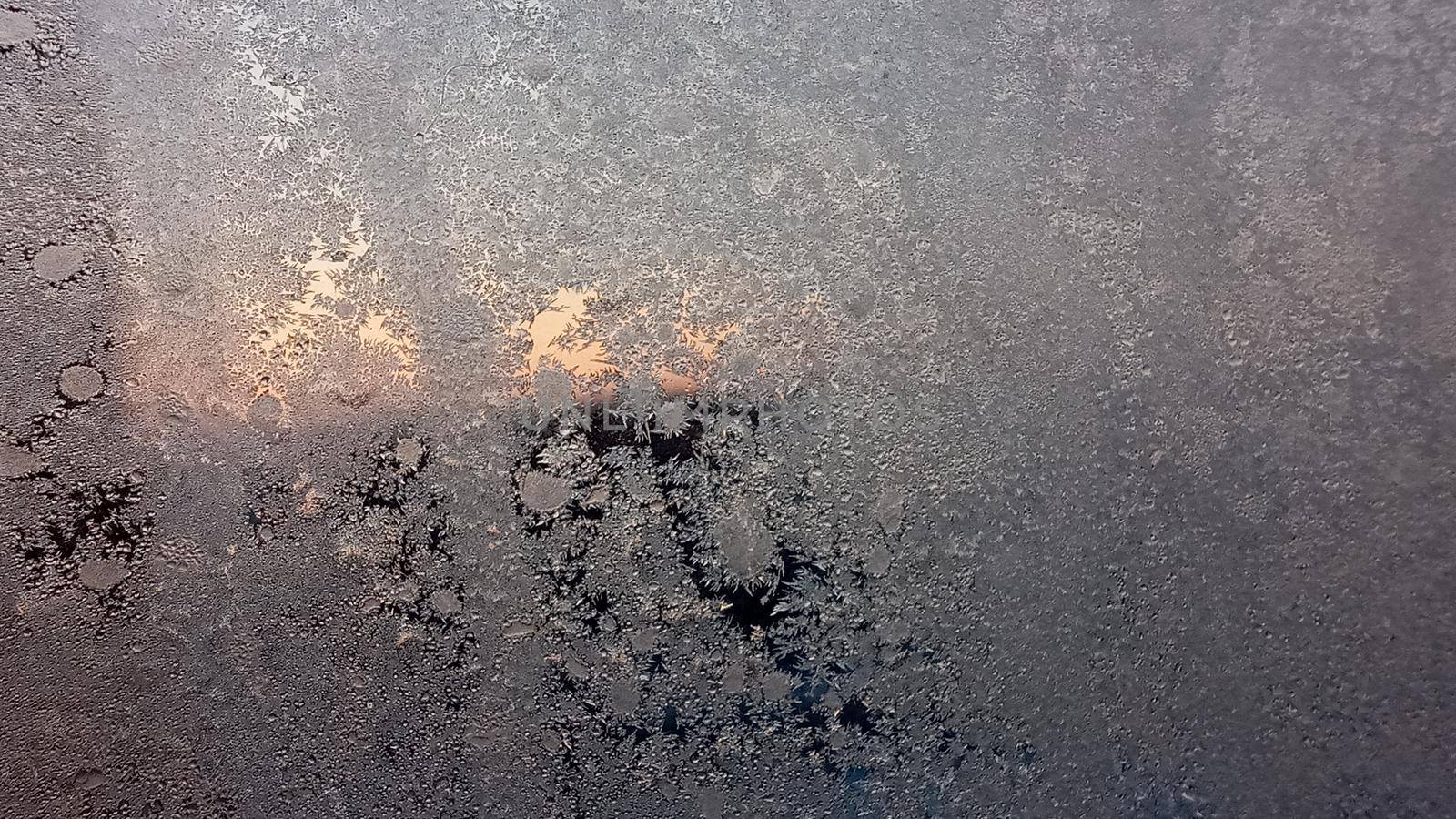 Frost texture on the window glass in winter. Ice Crystals in Winter Blue and Pink. by Rina_Dozornaya