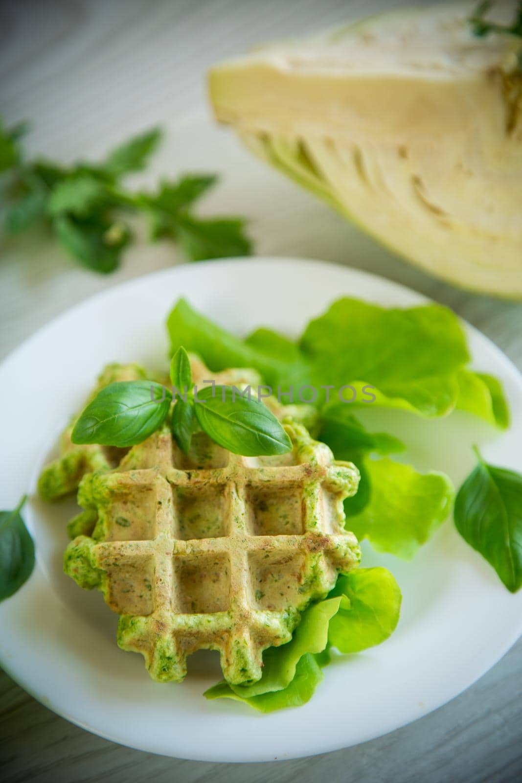 vegetable waffles cooked with herbs in a plate on a wooden table